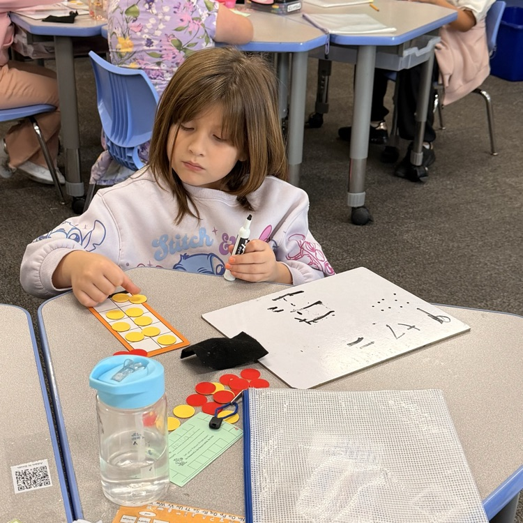 student using a whiteboard, counters, and a ten frame