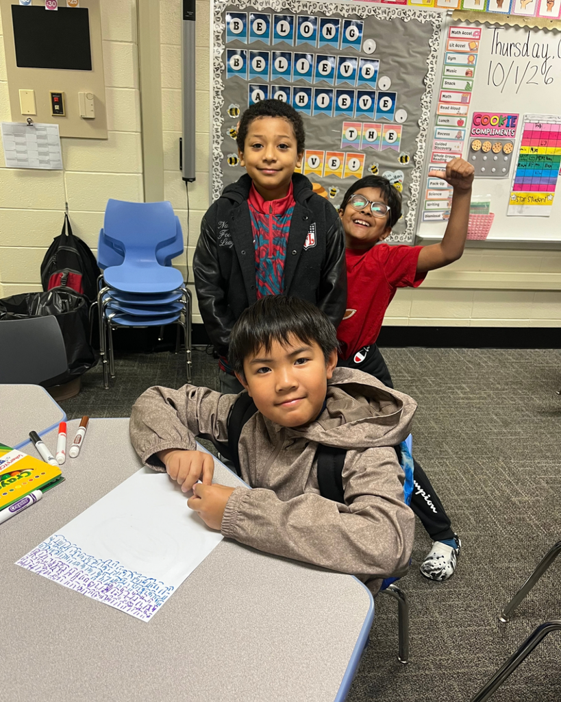 Students smiling together and drawing