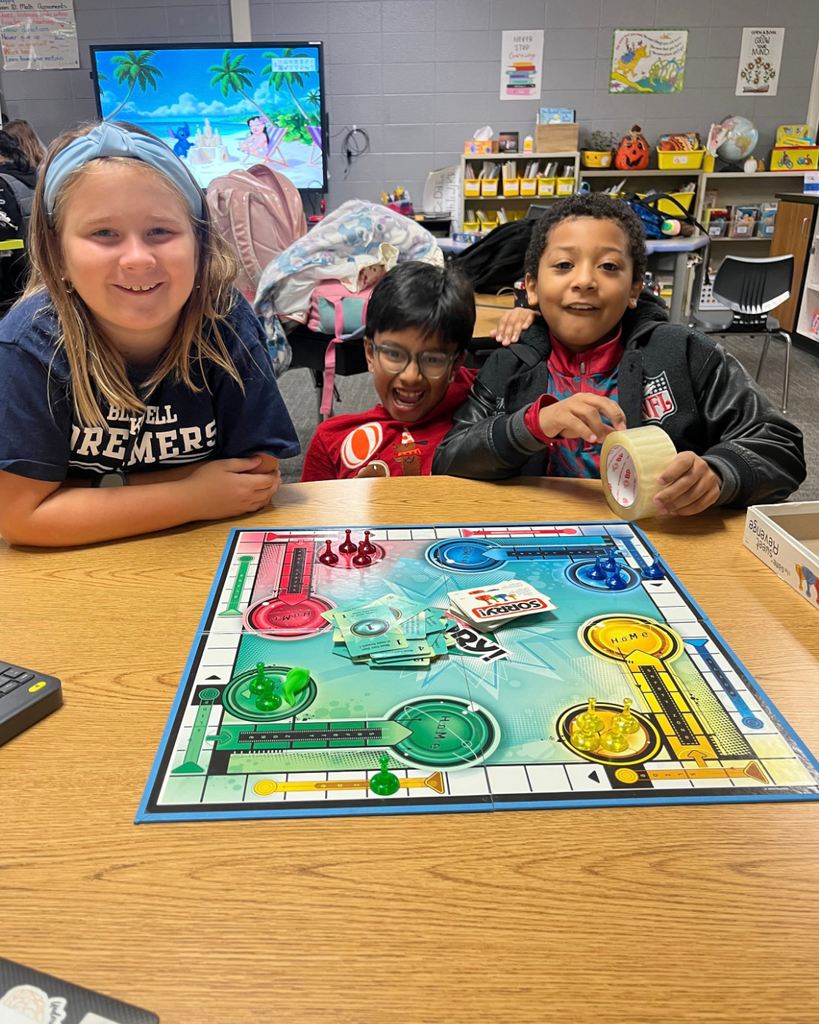 Students smiling while playing Sorry!