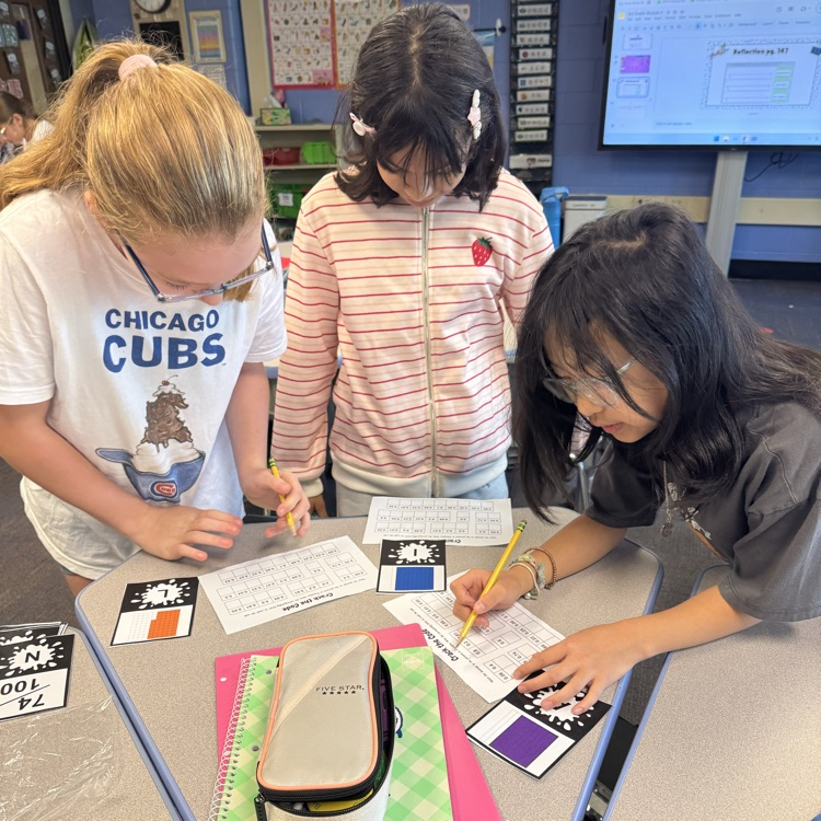 three students working on math activity in a group