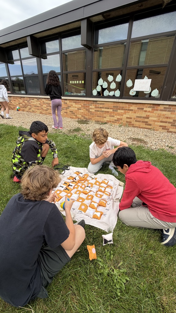 students playing chess on a giant chess board