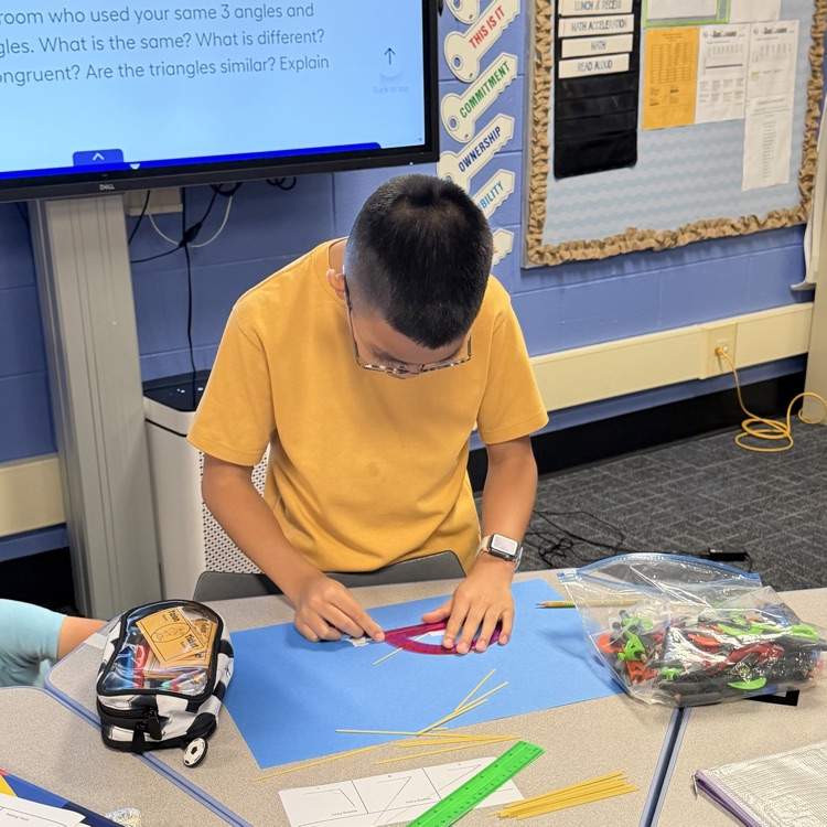 6th Grader using noodles to make triangle. 