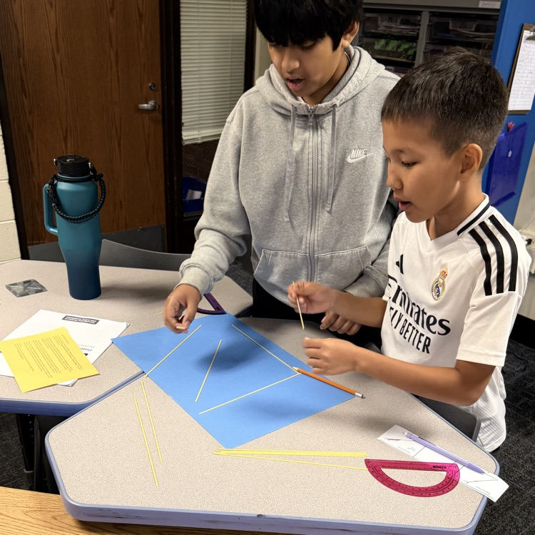 2 6th Graders using noodles to make triangle. 