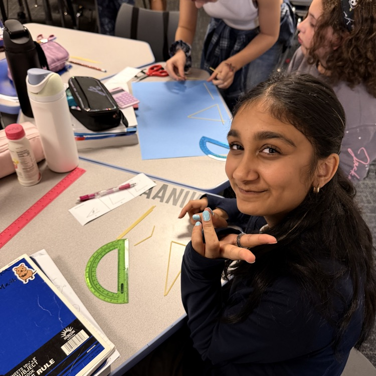 6th Grader using noodles to make triangle. 