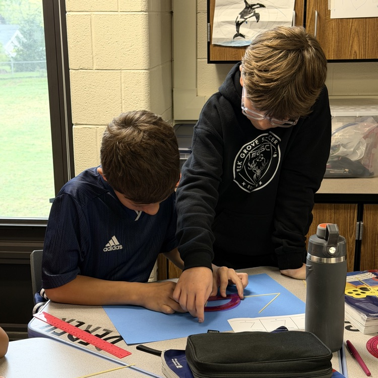 2 6th Graders using noodles to make triangle. 