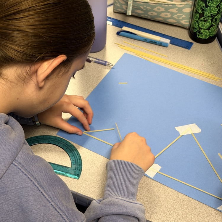 Designing a triangle with noodle pieces. 