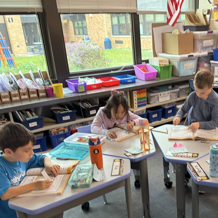 three students working on problems in math book