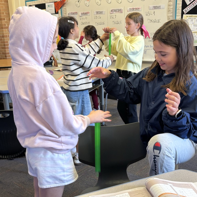 students holding a ruler and objects