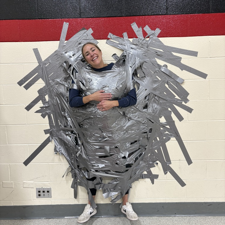 Principal taped to wall
