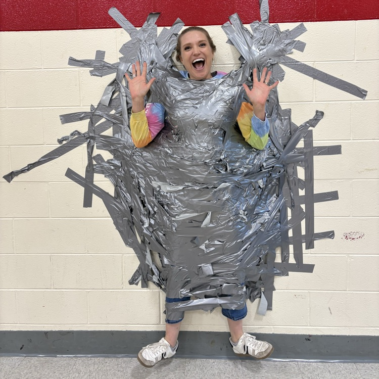 Principal taped to wall