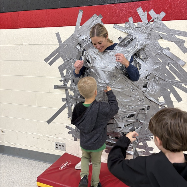 Principal taped to wall