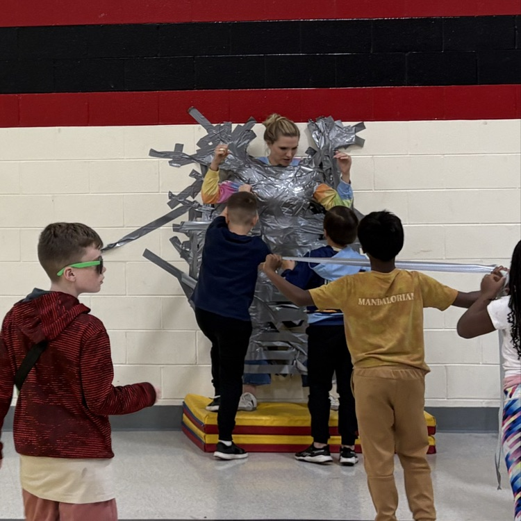 Principal taped to wall