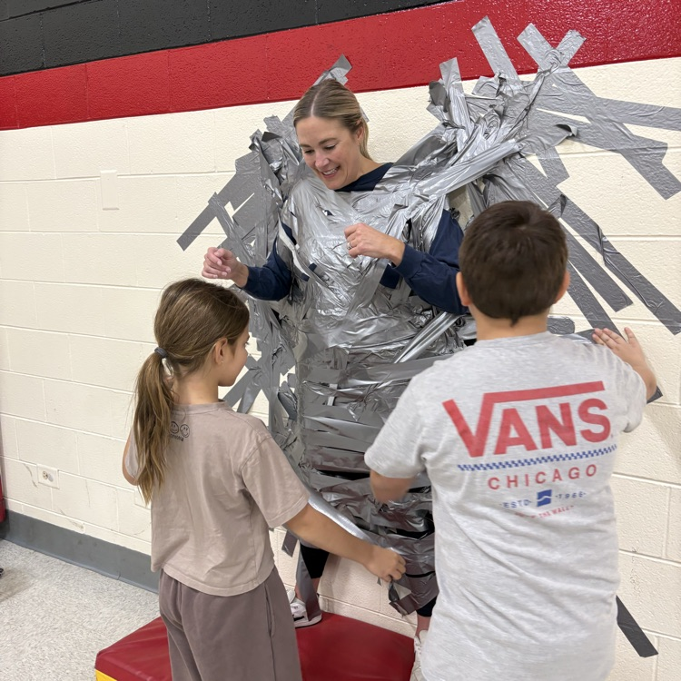 Principal taped to wall