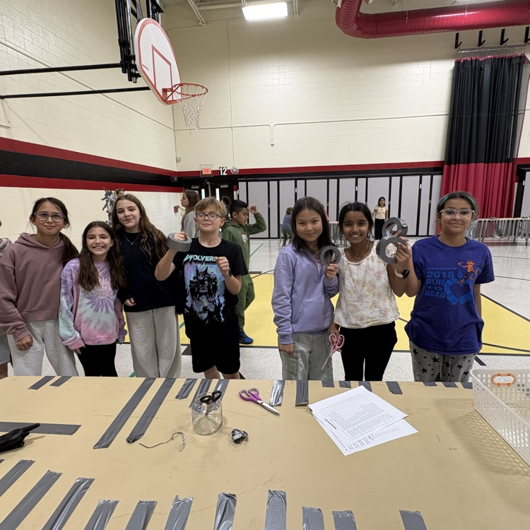 Principal taped to wall