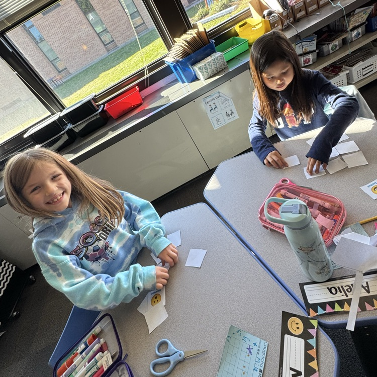 two girls working with emotions cards