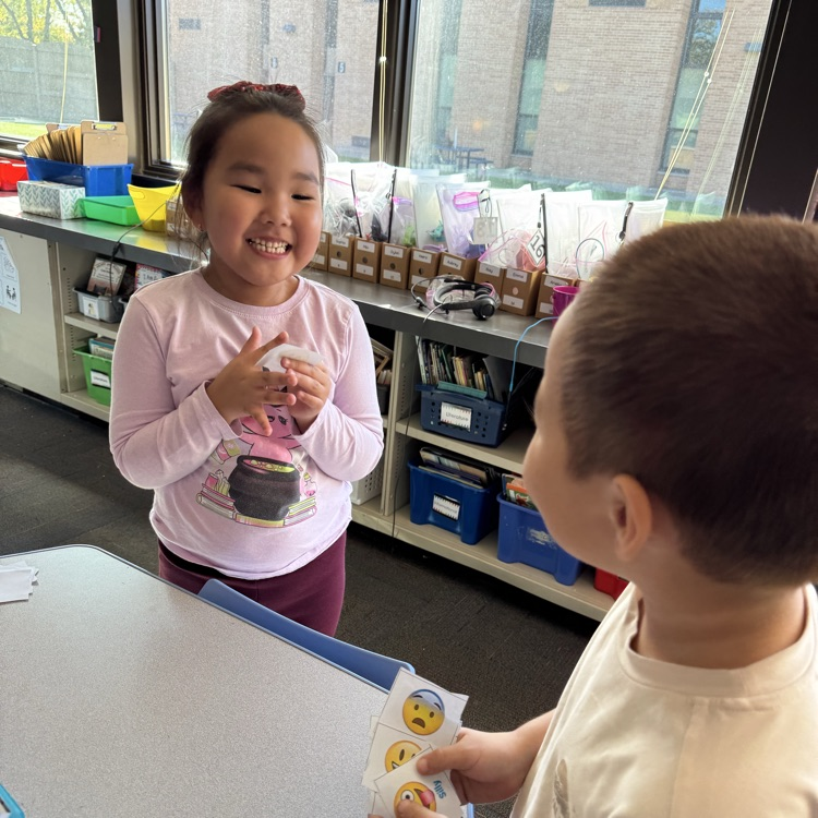 two students practicing with emotions cards