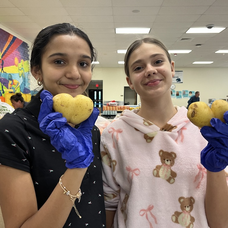 Wildcat students holding potatoes.