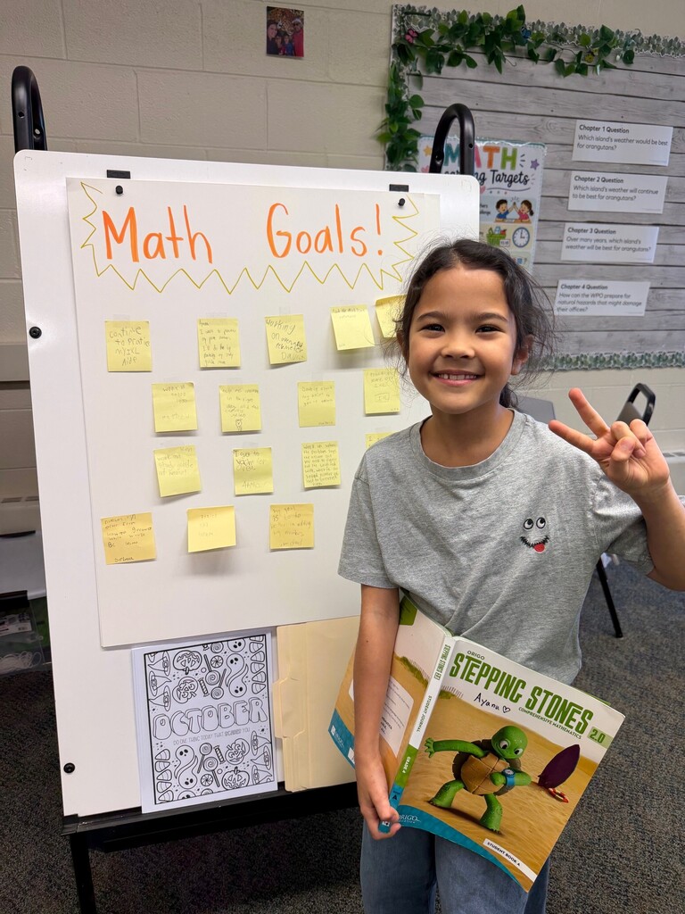 student smiling with math book