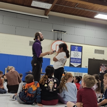 a girl talking on a microphone with the performer