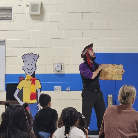 man holding a map and wearing a pirate hat