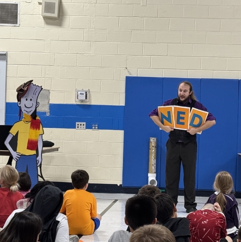 man holding sign that says Ned 