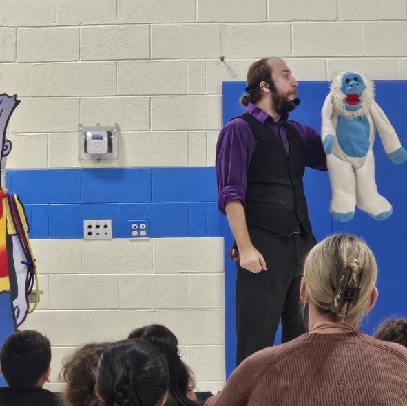 man holding a yeti puppet