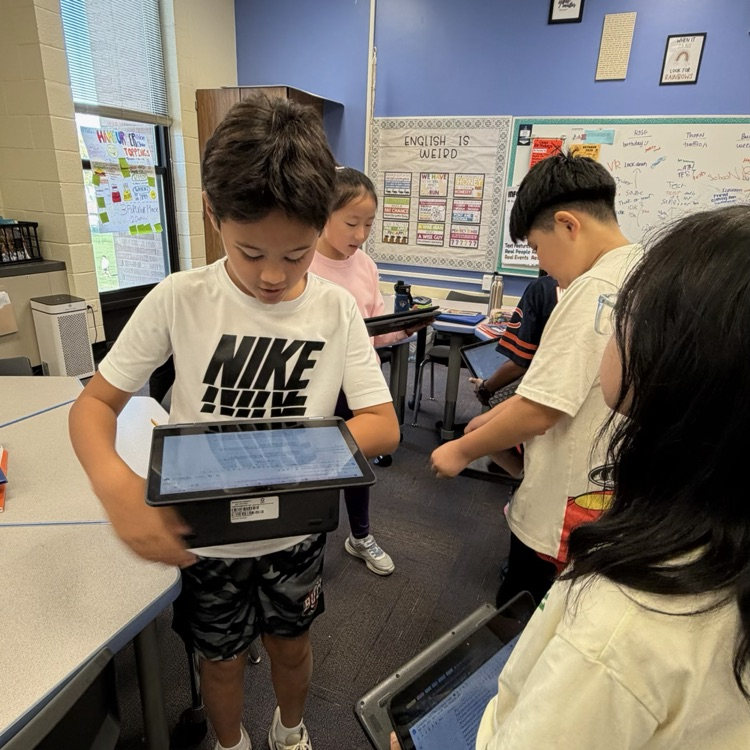 students looking at writing in their Chromebook