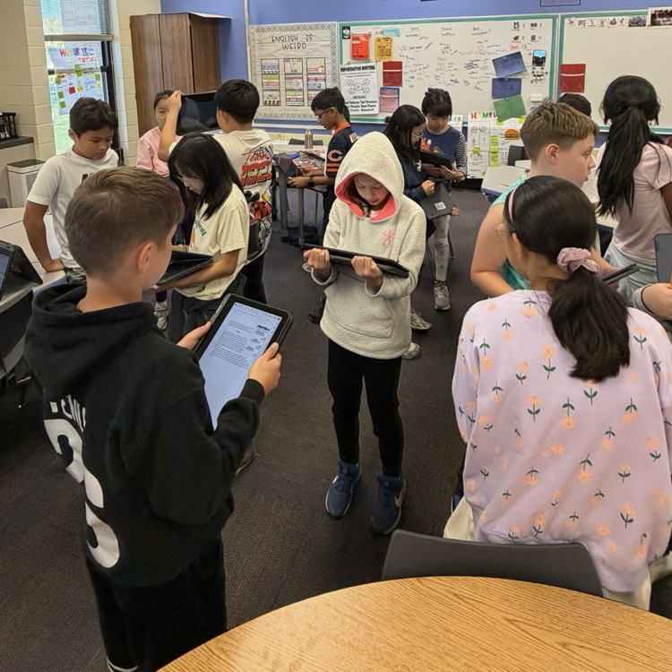 students looking at writing in their Chromebook