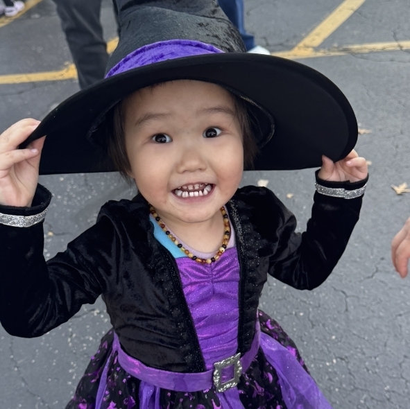 little girl dressed as a witch
