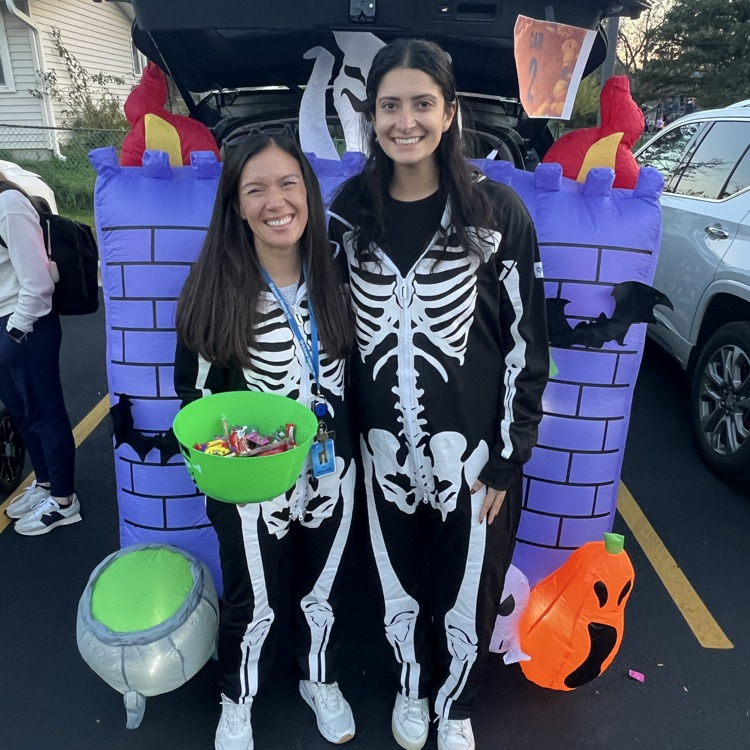 Dr. Houlihan and Mrs. Moradi standing by their decorated trunk