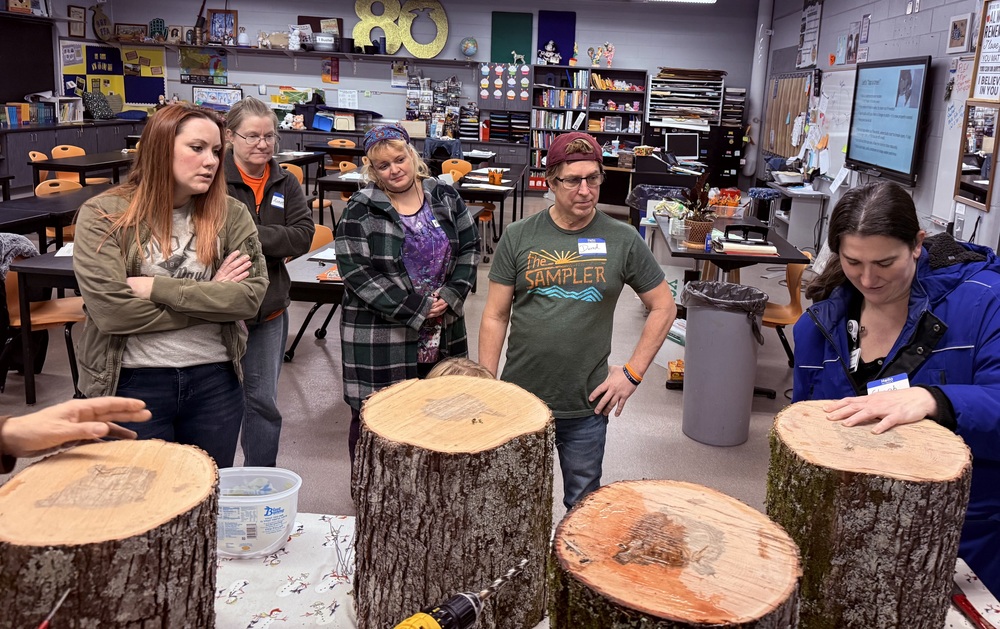 People looking at a woman who is practicing tree tapping.