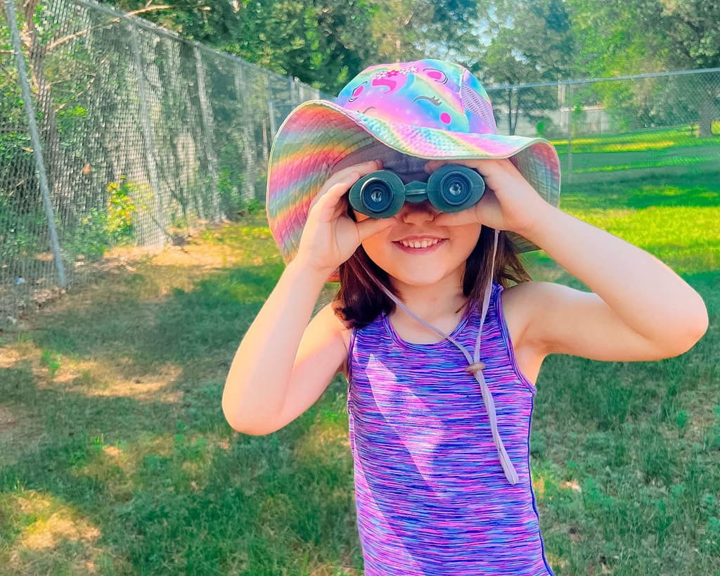 Child looking through binoculars