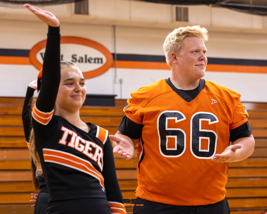 Cheerleader and football player wave
