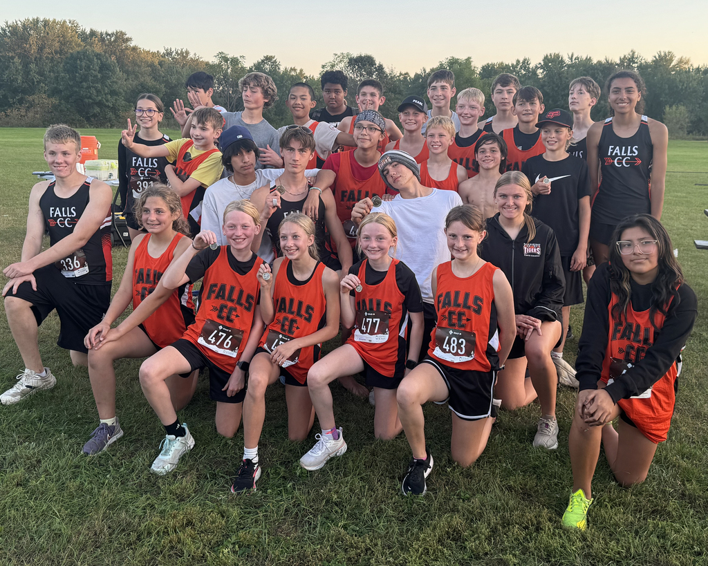 Cross country team posing with medals