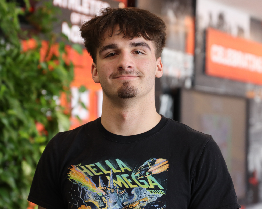 Boy in graphic t-shirt smiling in portrait