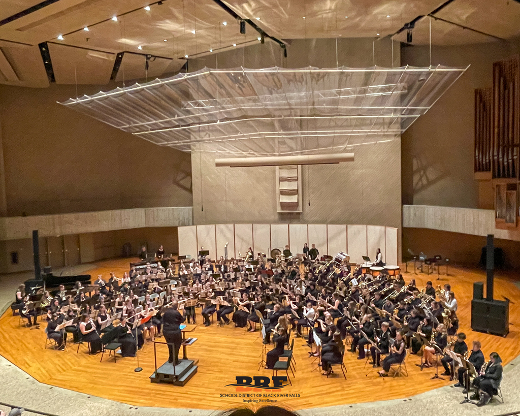 Ensemble playing a song in a concert hall.