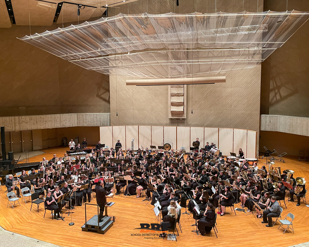 Ensemble playing a song in a concert hall.