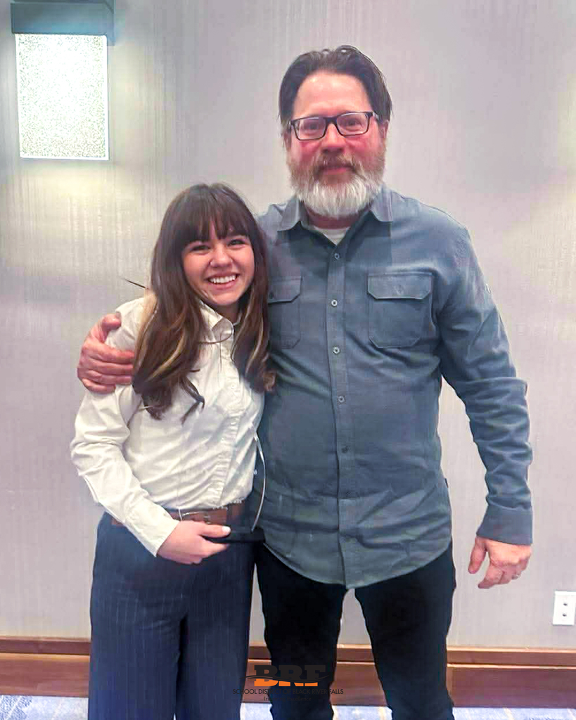 Athlete and coach posing together