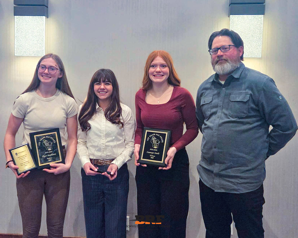 Athletes and coach posing together