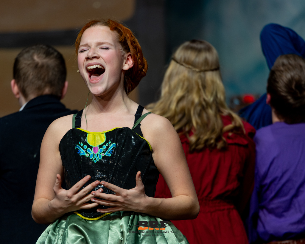 Girl sings on stage.