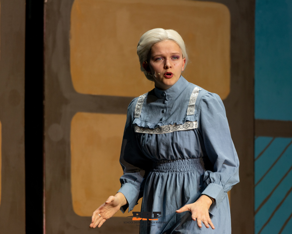 Girl sings on stage.