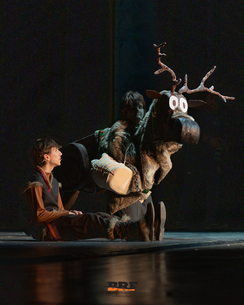 Actor sits next to another actor dressed as Sven.