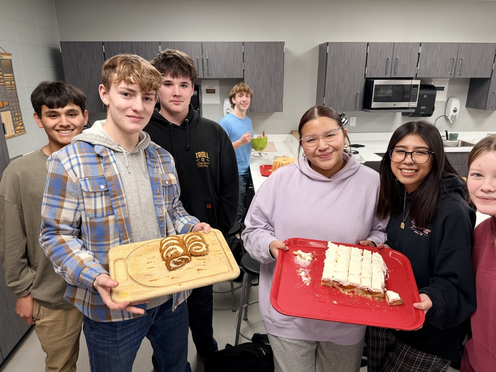 Teens holding out trays of deserts