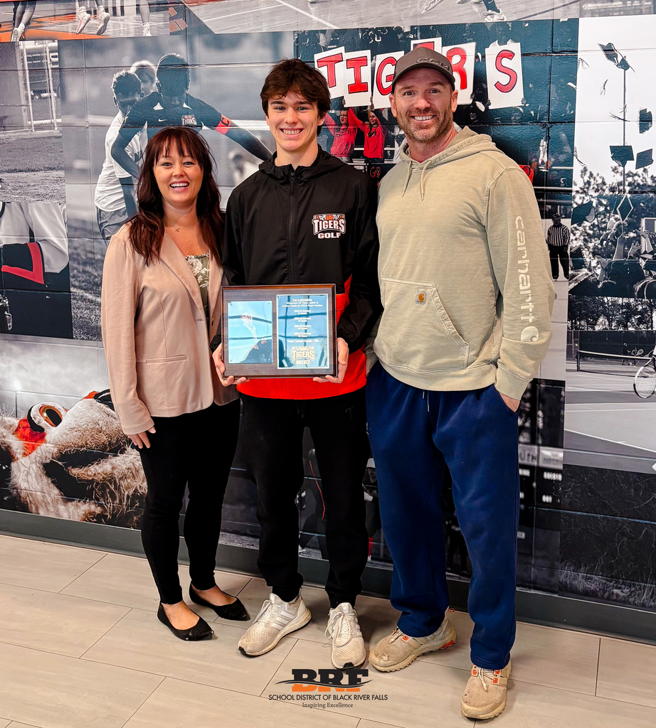 Three people standing in front of of a wall graphic.