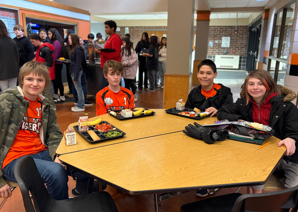 4 Boys eating lunch together