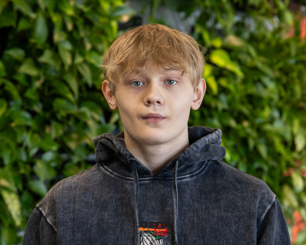 Boy in hoodie smiling in portrait