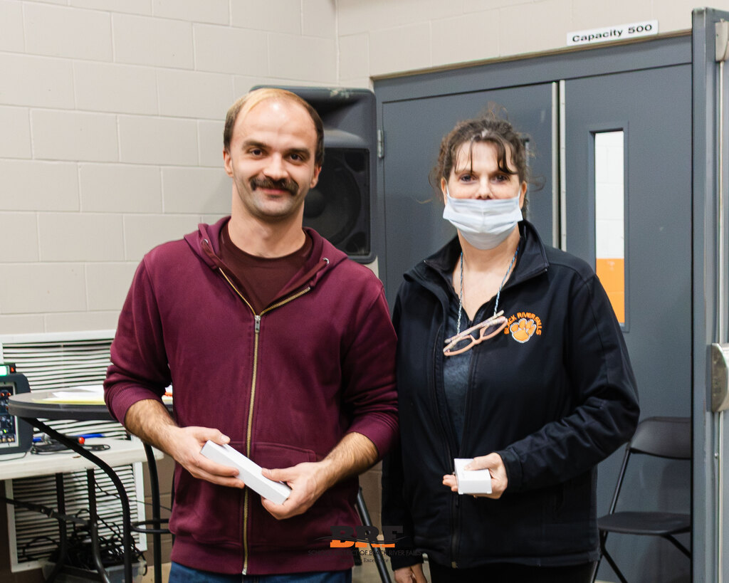 Two people holding boxes