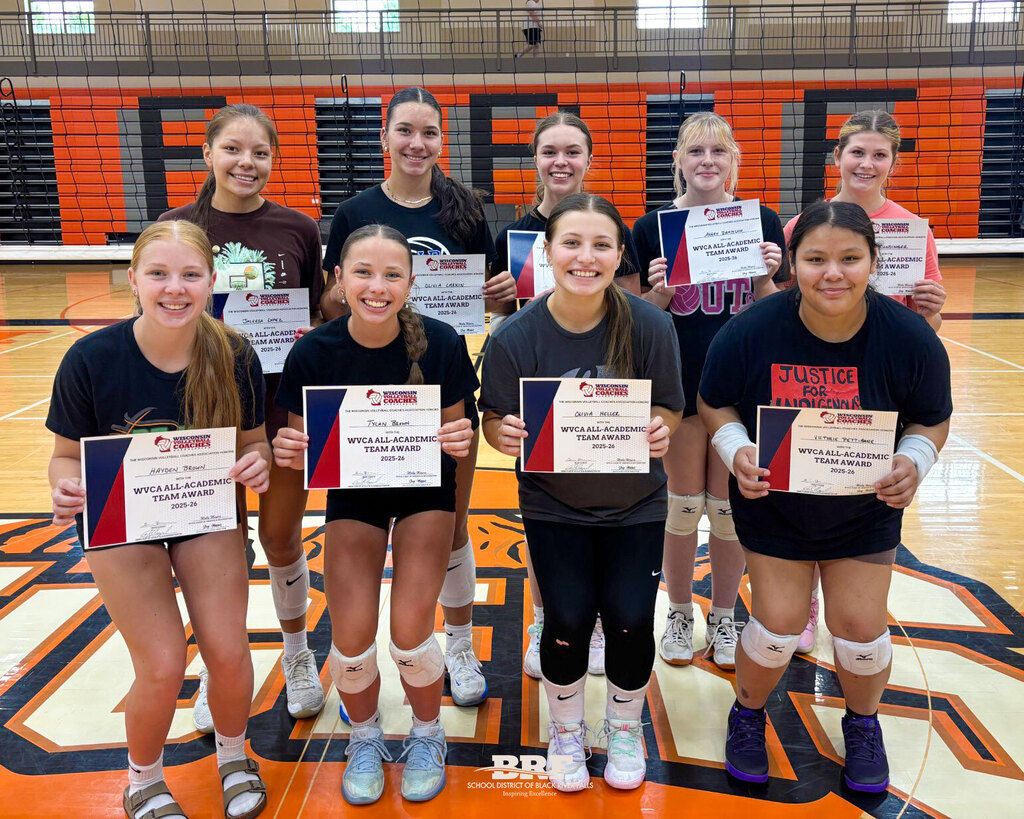 Nine girl standing in two rows, holding certificates.