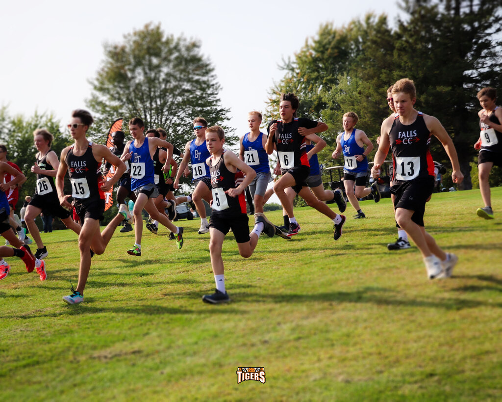Boys running on a grassy field
