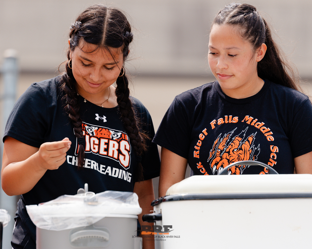 Two girls stand in front of roaster.